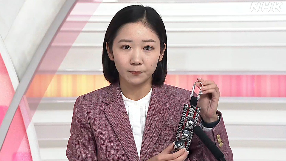 Reporter NHK Serizawa Marina memperlihatkan lonceng beruang miliknya.