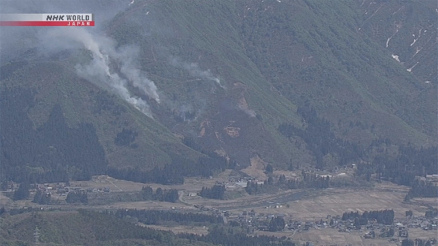 Petugas pemadam kebakaran berupaya menjinakkan kobaran api yang melanda area hutan di Prefektur Niigata.